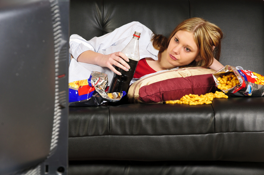 A pic of a woman eating junk food to show you the importance of self love to learn how to boost self esteem