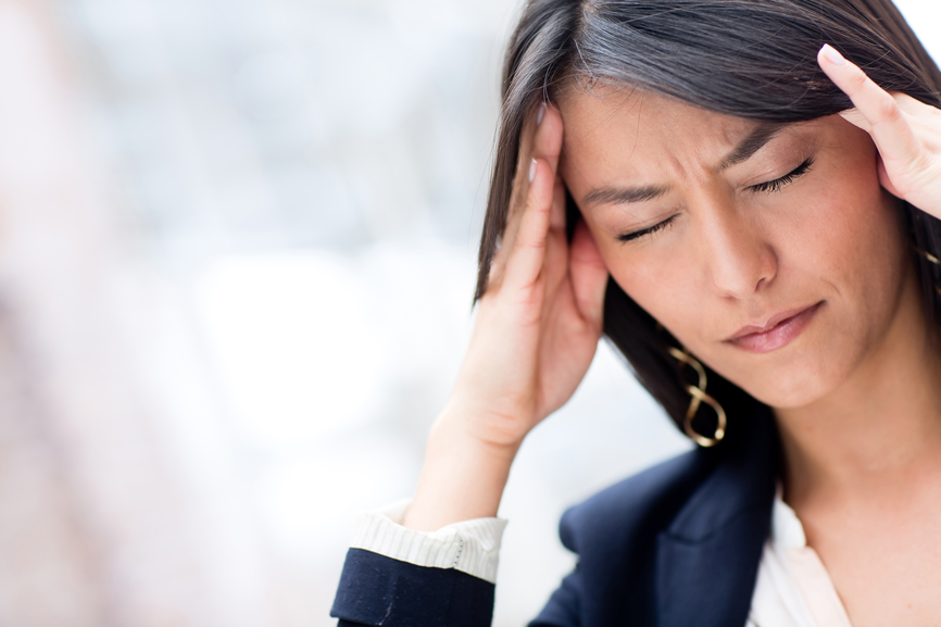 a pic of a woman with a headache as hypoglycemia is one of the weight gain causes