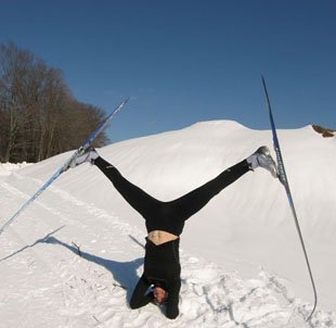 A pic of the author doing a headstand with cross country skis on showing how the West Island Naturopath loves to exercise and also loves snow